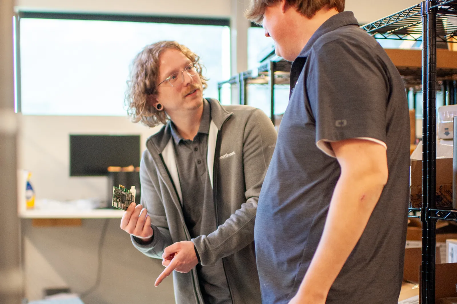 Two ThrottleNet technicians assembling a rack server on a bench