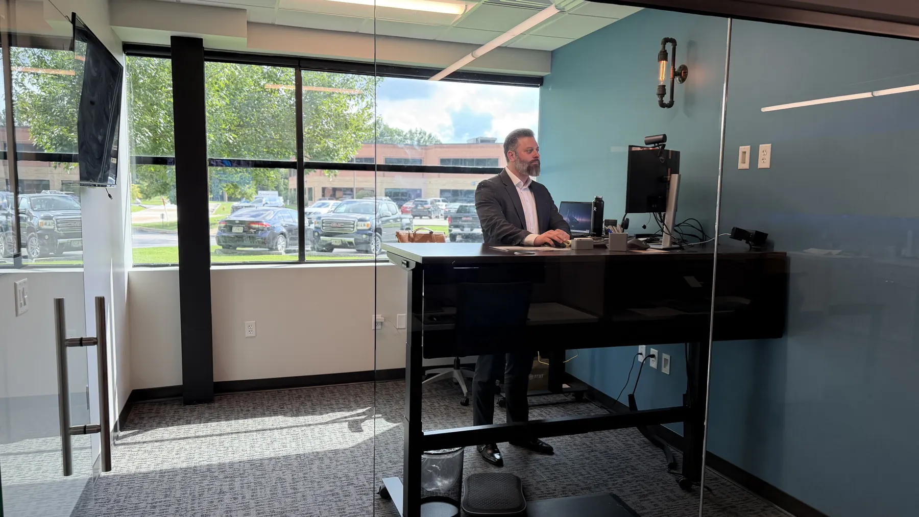 A ThrottleNet office with a standing desk beside a window overlooking the parking lot