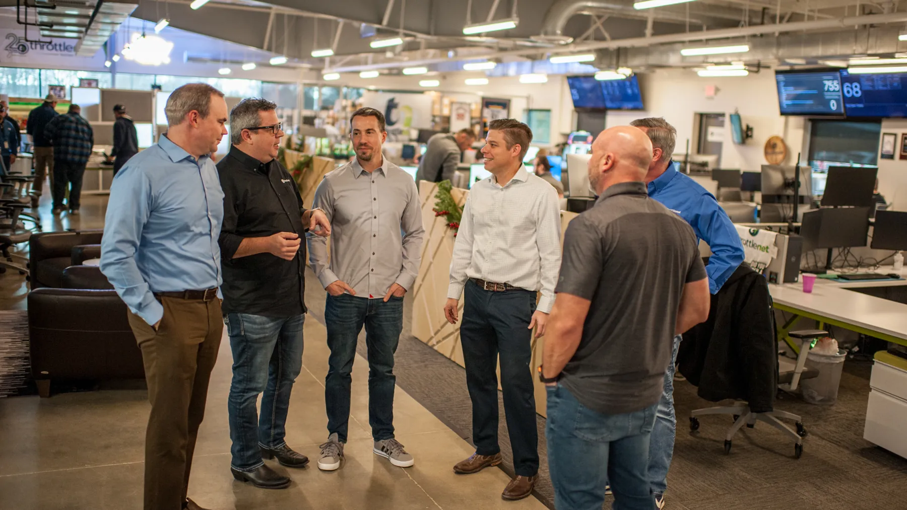 ThrottleNet leadership and technicians talking on the operations floor