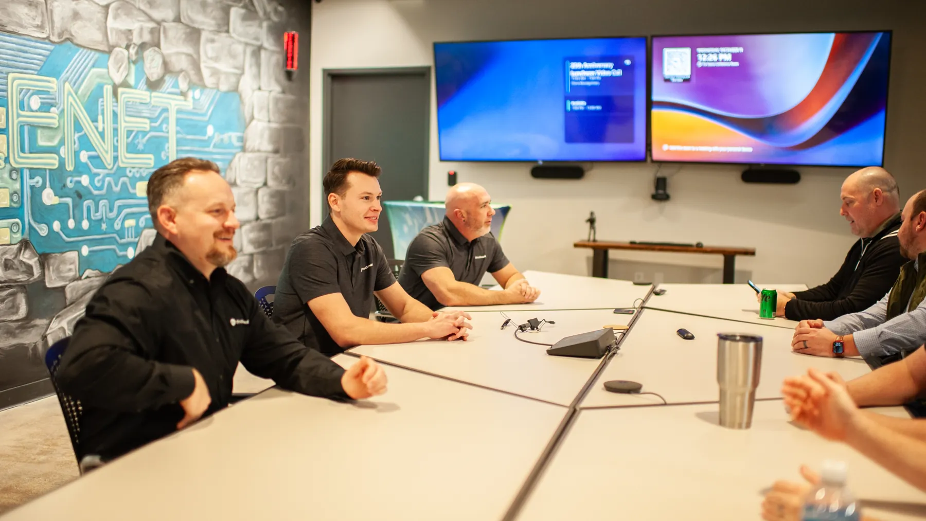 ThrottleNet staff around a conference table with service dashboards on the wall screens